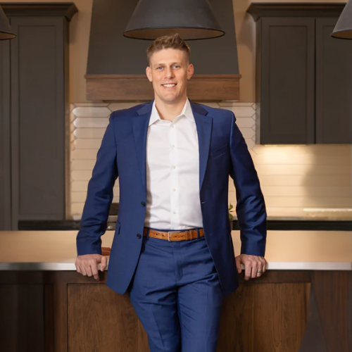 Keith McNeely, Madison WI realtor, standing in a modern kitchen